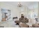 Spacious living room with hardwood floors, comfortable seating, and access to the staircase at 408 Tomahawk Trl, Mcdonough, GA 30252