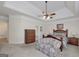 Spacious bedroom features a tray ceiling, ceiling fan, and closet at 408 Tomahawk Trl, Mcdonough, GA 30252