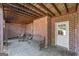Covered brick patio with wooden benches and ceiling fan, perfect for relaxing outdoors at 408 Tomahawk Trl, Mcdonough, GA 30252