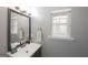 Well-lit half-bathroom featuring a sleek vanity, modern faucet, and decorative mirror at 1383 Dolcetto Nw Trce # 9, Kennesaw, GA 30152