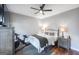 Comfortable bedroom with a ceiling fan, cozy decor, and wood floors, providing a serene retreat at 1383 Dolcetto Nw Trce # 9, Kennesaw, GA 30152
