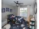 Charming bedroom featuring a space theme, ceiling fan, and natural light at 1383 Dolcetto Nw Trce # 9, Kennesaw, GA 30152