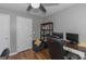 Bedroom featuring a wooden floor, ceiling fan, desk, and shelving unit at 1383 Dolcetto Nw Trce # 9, Kennesaw, GA 30152