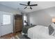 Cozy bedroom with a ceiling fan, mounted TV, and inviting natural light from the window at 1383 Dolcetto Nw Trce # 9, Kennesaw, GA 30152