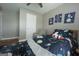 Inviting bedroom with space themed decor, ceiling fan, and comfortable furniture at 1383 Dolcetto Nw Trce # 9, Kennesaw, GA 30152