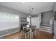 Charming dining area with wood floors, a modern chandelier, and sunlit windows at 1383 Dolcetto Nw Trce # 9, Kennesaw, GA 30152
