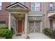 Charming townhome with a brick and gray exterior, complete with a one car garage and colorful shutters at 1383 Dolcetto Nw Trce # 9, Kennesaw, GA 30152