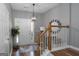 Inviting foyer with wooden railing staircase, stylish lighting, and sleek floors providing a modern and welcoming entrance at 1383 Dolcetto Nw Trce # 9, Kennesaw, GA 30152