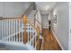 Bright hallway with stairs, hardwood floors, neutral walls, and modern track lighting, creating a welcoming entrance at 1383 Dolcetto Nw Trce # 9, Kennesaw, GA 30152