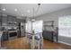 Modern kitchen with stainless steel appliances, grey cabinets, and a dining table with stools at 1383 Dolcetto Nw Trce # 9, Kennesaw, GA 30152