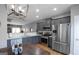 Modern kitchen with stainless steel appliances and grey cabinetry with breakfast table at 1383 Dolcetto Nw Trce # 9, Kennesaw, GA 30152
