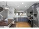 Well-lit kitchen with stainless steel appliances, grey cabinets, and a breakfast table at 1383 Dolcetto Nw Trce # 9, Kennesaw, GA 30152
