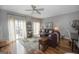 Spacious living room with hardwood floors, gray walls, ceiling fan, and a patio door leading to outdoor space at 1383 Dolcetto Nw Trce # 9, Kennesaw, GA 30152