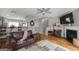 Inviting living room featuring hardwood floors, a cozy fireplace, and seamless transition to dining area at 1383 Dolcetto Nw Trce # 9, Kennesaw, GA 30152