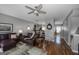 Open-concept living room with hardwood floors, gray walls, stylish furniture, and seamless access to the dining area at 1383 Dolcetto Nw Trce # 9, Kennesaw, GA 30152