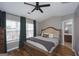 Comfortable main bedroom with hardwood floors, ceiling fan, and ensuite bathroom at 1383 Dolcetto Nw Trce # 9, Kennesaw, GA 30152