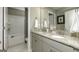 Bathroom with granite countertops, double sinks, a shower-tub combo, and neutral paint at 1716 Goodwin Dr, Hampton, GA 30228