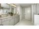 Well-lit bathroom showcasing a double vanity, modern mirrors and tiled floors at 1716 Goodwin Dr, Hampton, GA 30228