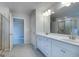 Bathroom with double vanity, tile floors, walk-in shower and access to a second room at 1716 Goodwin Dr, Hampton, GA 30228