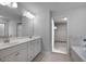 Modern bathroom features a double vanity, tile floors, and a walk-in closet at 1716 Goodwin Dr, Hampton, GA 30228