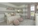 Charming bedroom featuring decorative wall art and neutral-toned furniture and carpeting at 1716 Goodwin Dr, Hampton, GA 30228