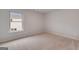 Bright bedroom featuring neutral walls and plush carpeting, complemented by a large window at 1716 Goodwin Dr, Hampton, GA 30228