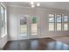 Bright dining area with wood floors and large windows, providing ample natural light at 1716 Goodwin Dr, Hampton, GA 30228