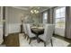 Bright dining room featuring a coffered ceiling, elegant lighting, and large windows at 1716 Goodwin Dr # 76, Hampton, GA 30228