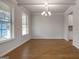 Dining area with tray ceiling, rich floors, and bright windows create a bright and open space at 1716 Goodwin Dr, Hampton, GA 30228
