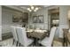 Dining room with views, featuring modern furniture and decorative lighting at 1716 Goodwin Dr, Hampton, GA 30228
