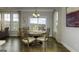 Cozy dining room with hardwood floors, decorative lighting, and views of the outdoor landscape at 1716 Goodwin Dr, Hampton, GA 30228