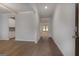 A hallway with sleek wood floors connects invitingly to other spaces in the home at 1716 Goodwin Dr, Hampton, GA 30228