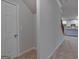 Hallway featuring a closet, entrance to kitchen, and a staircase at 1716 Goodwin Dr, Hampton, GA 30228