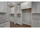 Bright kitchen with white cabinets, granite countertops, stainless steel appliances, and hardwood floors at 1716 Goodwin Dr, Hampton, GA 30228