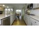 Modern kitchen featuring stainless steel appliances, granite countertops, and hardwood flooring leading to the breakfast nook at 1716 Goodwin Dr, Hampton, GA 30228