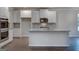 Bright kitchen features white cabinets, stainless steel appliances, and a granite island at 1716 Goodwin Dr, Hampton, GA 30228