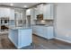 Modern kitchen with white cabinets, a granite island, stainless steel appliances, and hardwood floors at 1716 Goodwin Dr, Hampton, GA 30228