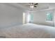 Spacious main bedroom with a tray ceiling and large windows, offering plenty of natural light at 1716 Goodwin Dr, Hampton, GA 30228