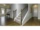 Elegant staircase featuring hardwood floors, carpeted steps, and wrought iron railings at 1716 Goodwin Dr, Hampton, GA 30228
