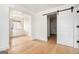 Bright and airy room showcasing light wood floors and a sliding barn door at 3365 Turtle Lake Se Dr, Marietta, GA 30067