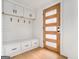 Welcoming entryway with white bench seating, drawers, storage and a wood grain paneled door at 3365 Turtle Lake Se Dr, Marietta, GA 30067