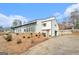 Striking modern home featuring a unique architectural design, multi-pane windows, and a driveway to the attached garage at 3365 Turtle Lake Se Dr, Marietta, GA 30067