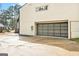 Exterior view of the garage featuring a stylish glass panel door and concrete driveway at 3365 Turtle Lake Se Dr, Marietta, GA 30067