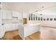 Bright, modern kitchen with white cabinetry, large island, and an array of windows at 3365 Turtle Lake Se Dr, Marietta, GA 30067