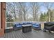 Relaxing back deck area with a stylish cushioned seating area, a fire pit, and grill at 1133 Astoria Ln, Peachtree City, GA 30269