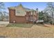 Expansive backyard showing brick exterior with spacious yard, deck and patio at 1133 Astoria Ln, Peachtree City, GA 30269