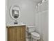 Cozy bathroom featuring a wood vanity with white countertop, oval mirror, and a shower with white curtain at 1133 Astoria Ln, Peachtree City, GA 30269