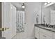 Bright bathroom features white cabinetry, granite countertops, and a shower with a patterned curtain at 1133 Astoria Ln, Peachtree City, GA 30269