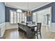 Elegant dining room boasts a wooden table, wainscoting, and a chandelier, perfect for Gathering gatherings at 1133 Astoria Ln, Peachtree City, GA 30269