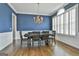 Elegant dining room featuring blue walls, hardwood floors, and a stylish chandelier at 1133 Astoria Ln, Peachtree City, GA 30269
